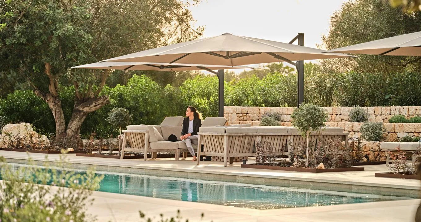 Ambiente nova cantilever umbrella by a pool