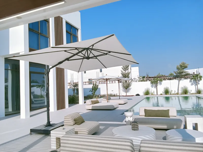Fortano cantilever umbrella shading a sofa lounge area beside a pool in Jubail Island